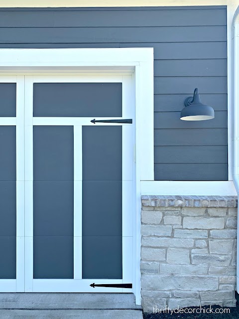 Dark gray and white garage doors with trim